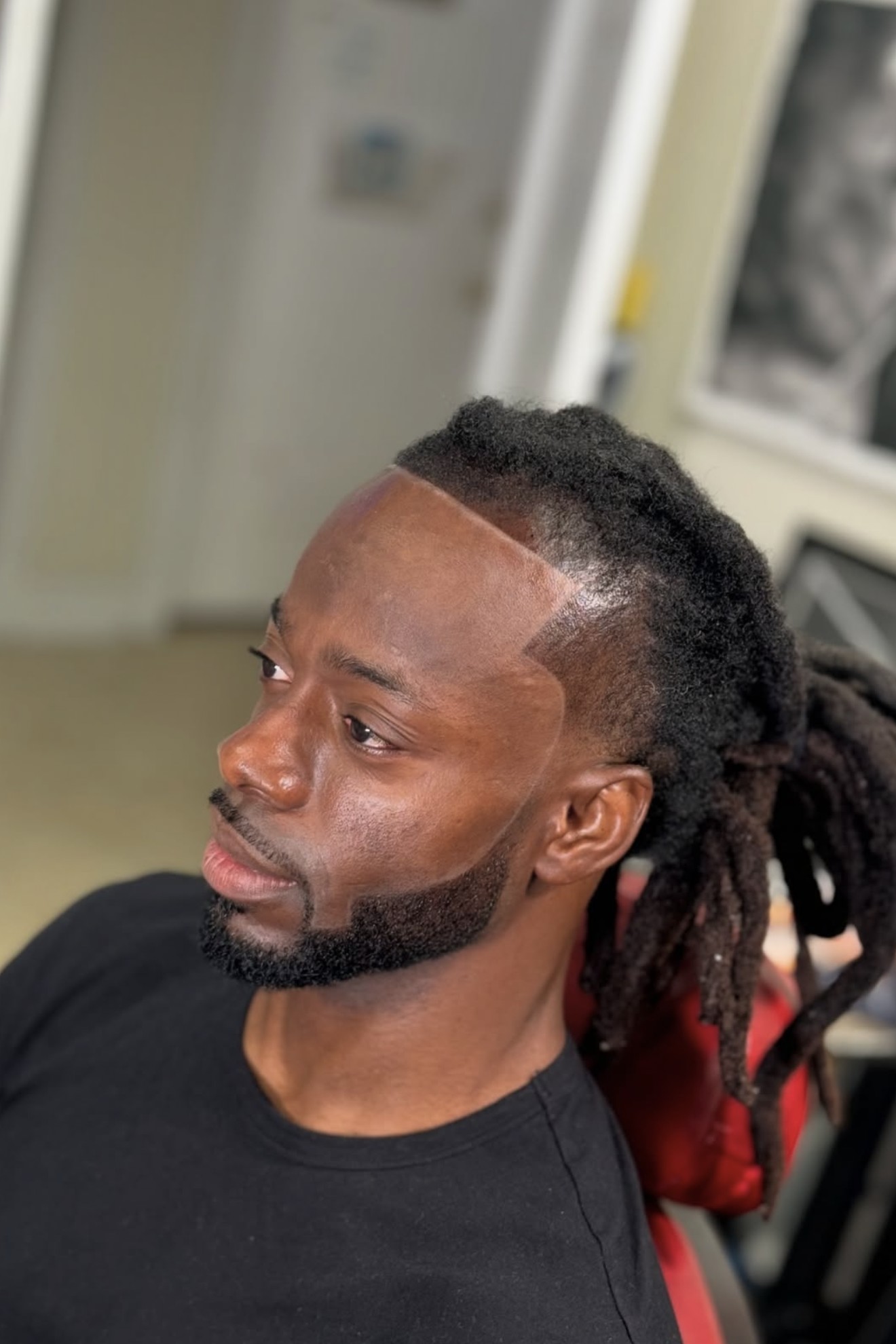 Locs with a precise line up and beard sculpt